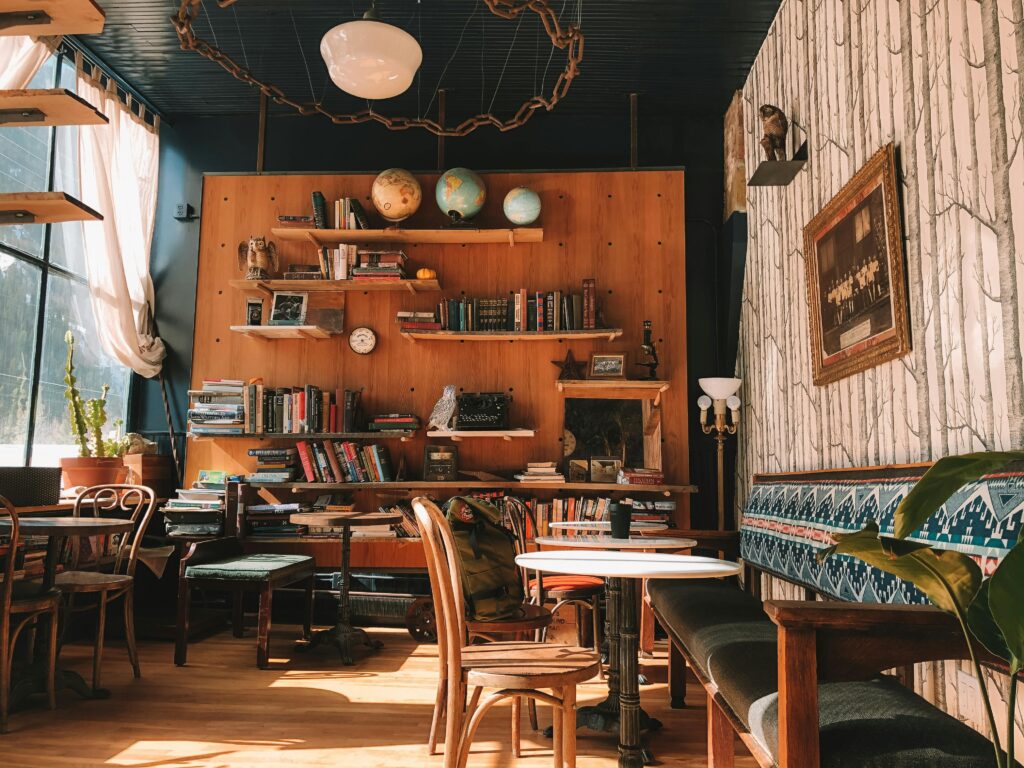 A charming cafe setting in Silver Plume featuring books, globes, and vintage decor. Ideal for cozy reading sessions.